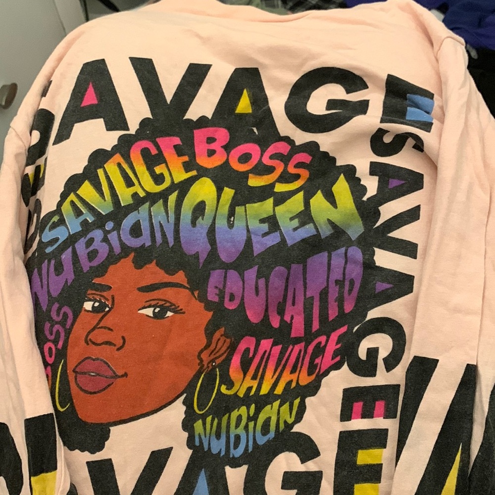 This shirt is pink with words on it as a black girl